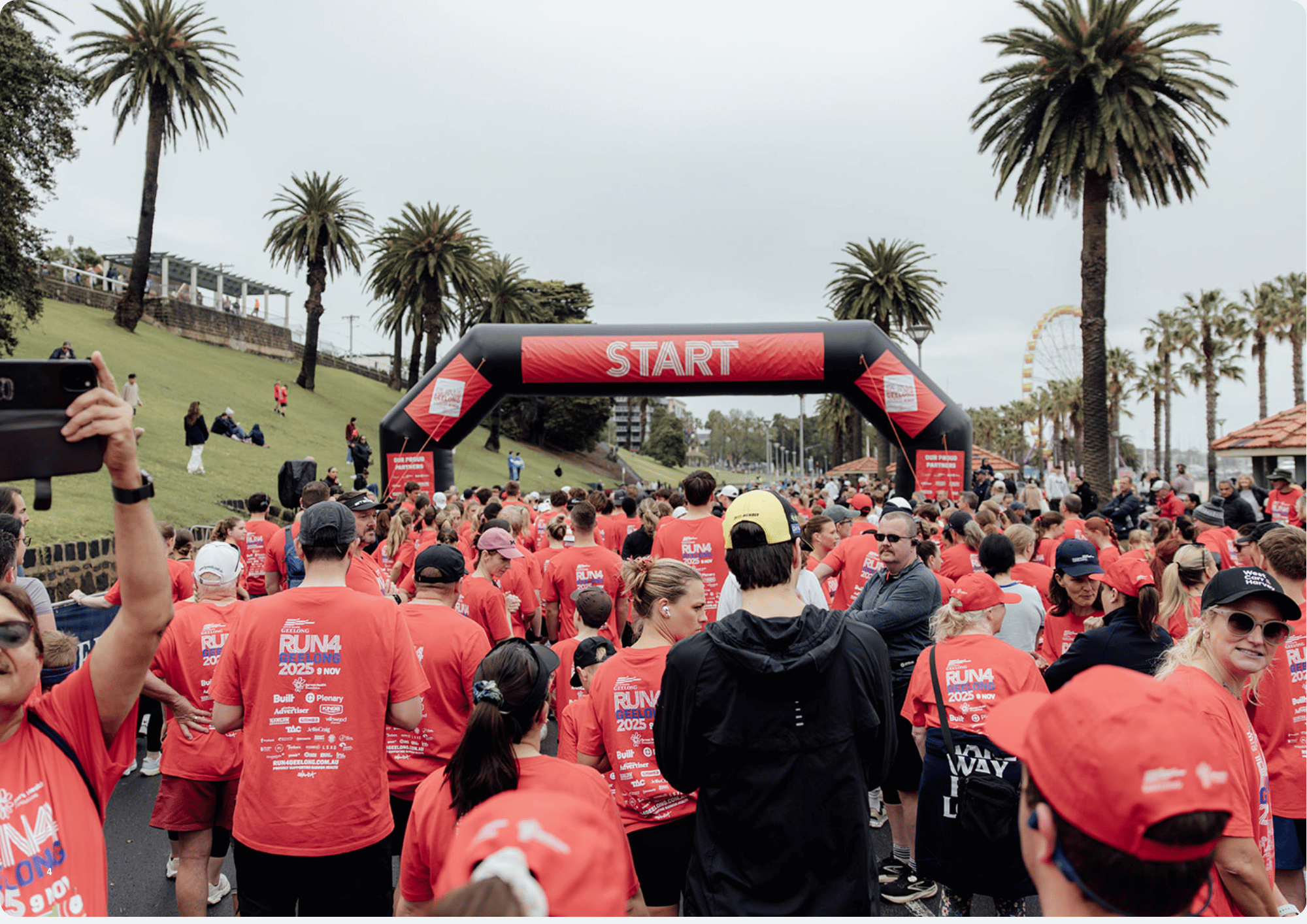 The Run4Geelong crowd gathered behind the finish line arch