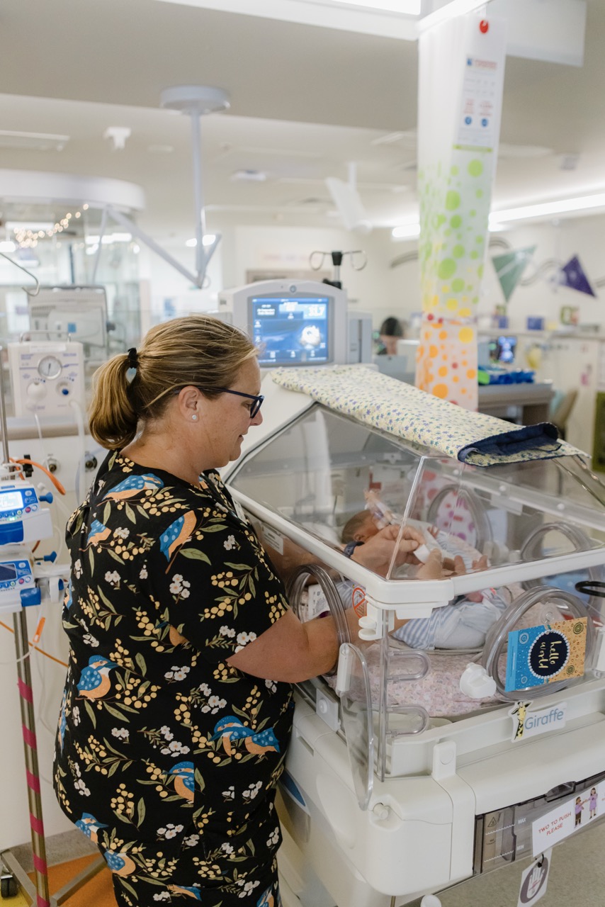 A nurse caring for a newborn baby